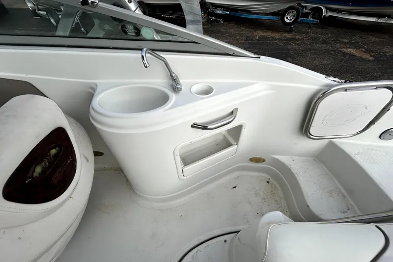 Slide: The Image of 2005 Crownline 220 LS boat interior with sink and storage compartment. - 23