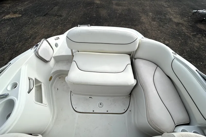 Slide: The Image of Interior seating of a 2005 Crownline 220 LS boat, featuring white cushioned seats. - 24