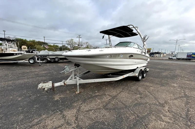 Slide: The Image of 2005 Crownline 220 LS boat on trailer in parking lot, overcast sky. - 3