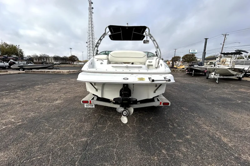 Slide: The Image of 2005 Crownline 220 LS boat on trailer in parking lot, rear view. - 6