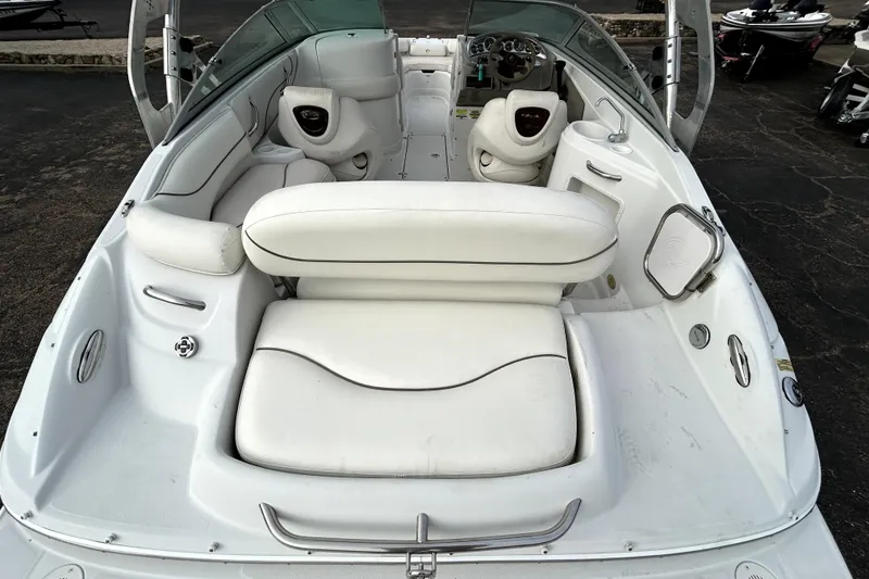 Slide: The Image of 2005 Crownline 220 LS boat interior with white seating and dashboard view. - 8