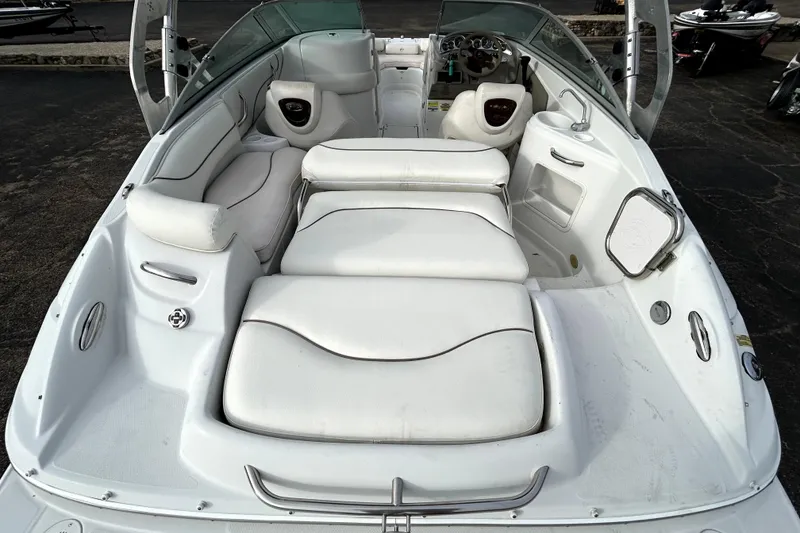 Slide: The Image of 2005 Crownline 220 LS boat interior with white seating and dashboard view. - 9