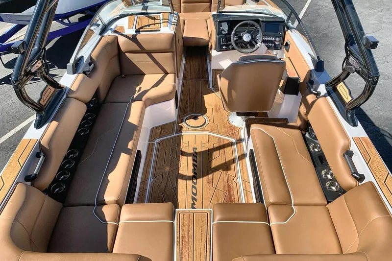 Slide: The Image of 2026 Moomba Max boat interior with tan seating and sleek dashboard design. - 10