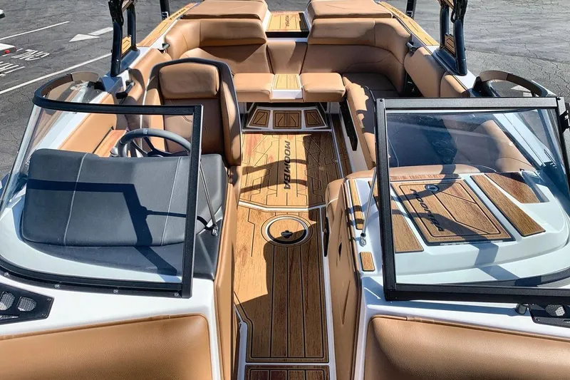 Slide: The Image of 2026 Moomba Max boat interior with tan seating and wood accents. - 12