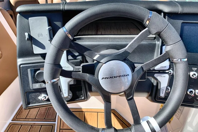 Slide: The Image of Steering wheel of 2026 Moomba Max boat with control panel and sleek design. - 14