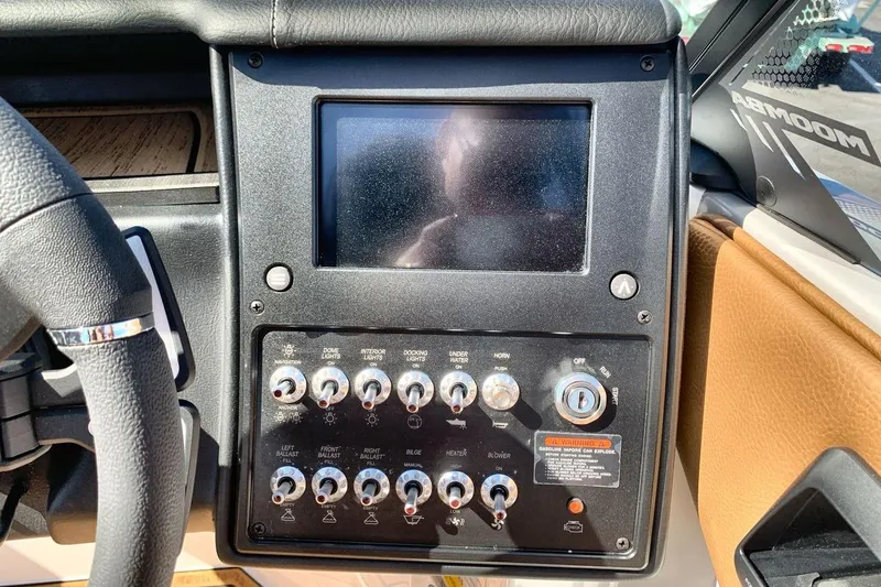 Slide: The Image of 2026 Moomba Max boat dashboard with control panel and touchscreen display. - 15