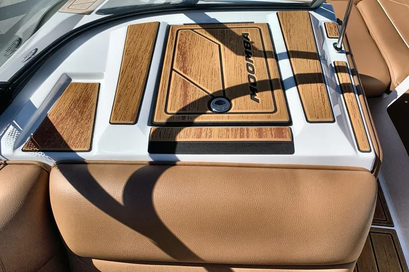 Slide: The Image of 2026 Moomba Max boat interior with tan upholstery and wood accents. - 18