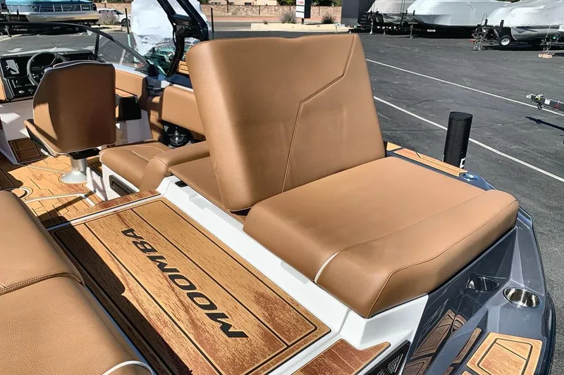 Slide: The Image of 2026 Moomba Max boat interior with tan leather seats and wood accents. - 19
