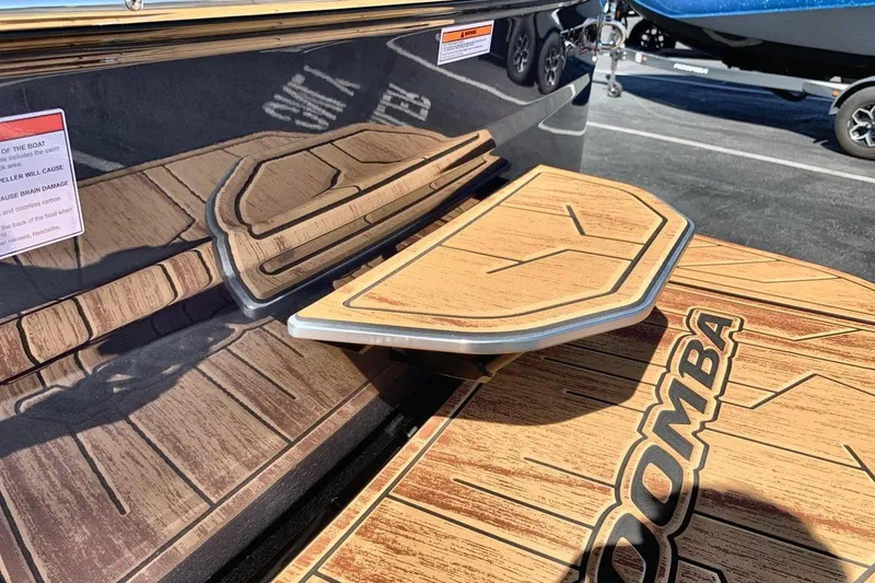 Slide: The Image of 2026 Moomba Max boat with wood-textured swim platform and step detail. - 22