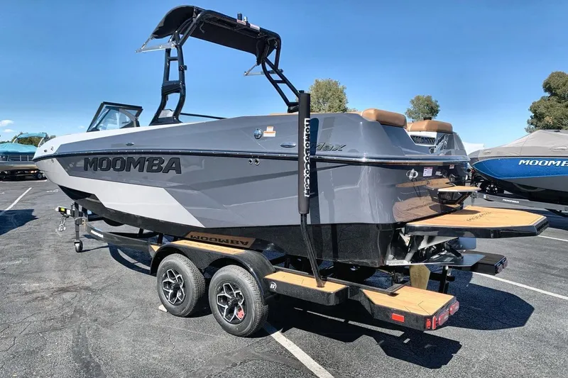 Slide: The Image of 2026 Moomba Max boat on trailer, sleek design, gray exterior, ready for water adventures. - 3