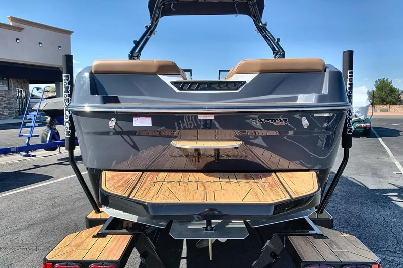 Slide: The Image of 2026 Moomba Max boat rear view with wooden deck and Raptor engine branding. - 4