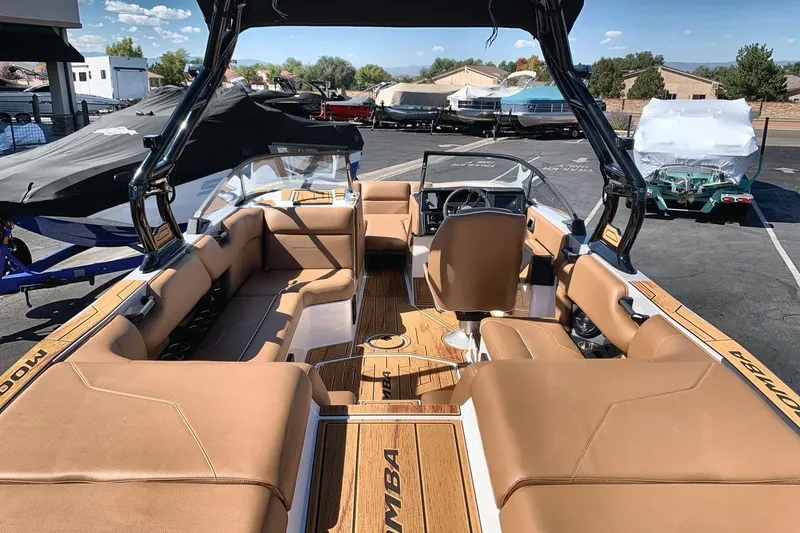 Slide: The Image of 2026 Moomba Max boat interior with tan seating and sleek design. - 9