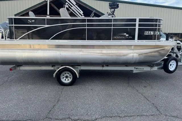The Image of 2022 Bennington S 18 Fishing pontoon boat on trailer, parked outdoors. - 0