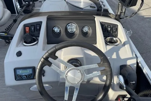 Slide: The Image of 2022 Bennington S 18 Fishing boat dashboard with steering wheel and control panel. - 13