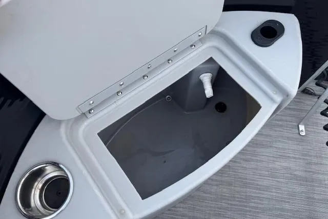 Slide: The Image of Livewell compartment on a 2022 Bennington S 18 Fishing boat, featuring cup holder and drain. - 19