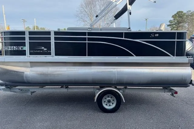 Slide: The Image of 2022 Bennington S 18 Fishing pontoon boat on trailer, side view. - 2