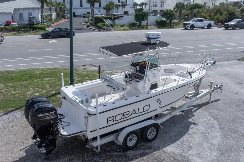 Slide: The Image of 1997 Robalo R230 Center Console boat on trailer with dual Mercury engines. - 12