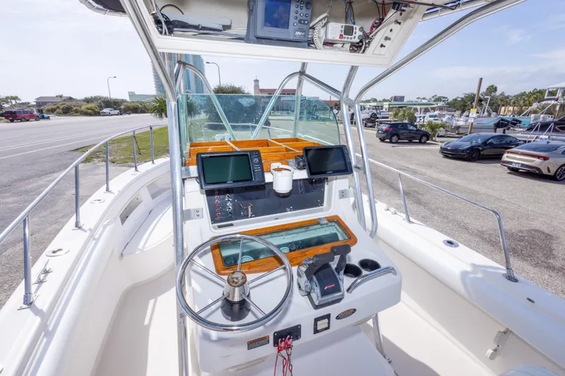 Slide: The Image of 1997 Robalo R230 Center Console boat interior with steering wheel and navigation equipment. - 18