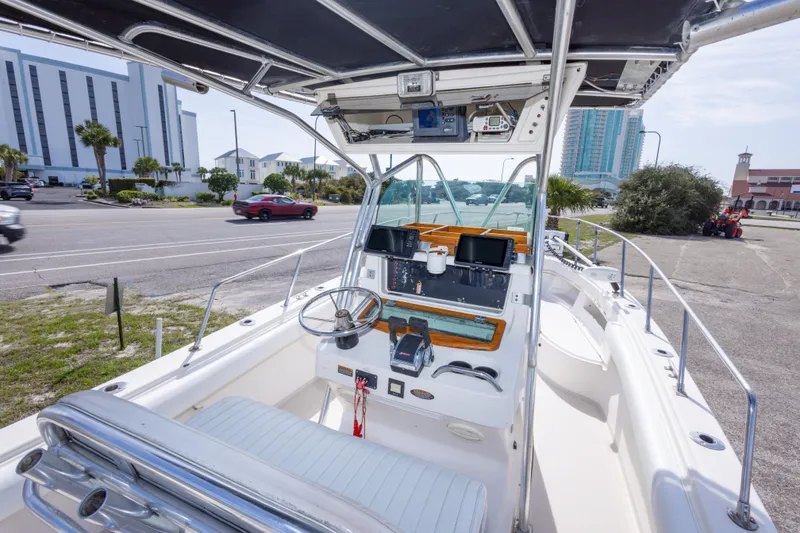 Slide: The Image of 1997 Robalo R230 Center Console boat interior with steering wheel and navigation equipment. - 21