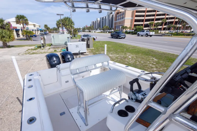 Slide: The Image of 1997 Robalo R230 Center Console boat interior with dual engines, parked near a road. - 24