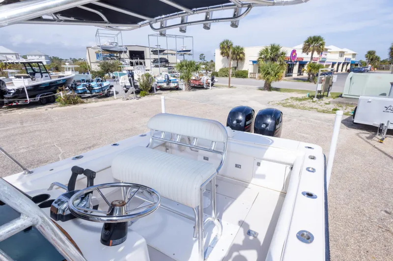 Slide: The Image of 1997 Robalo R230 Center Console boat with dual engines, parked near other boats. - 25