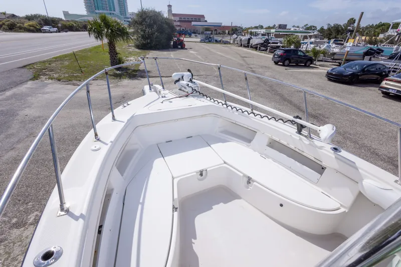 Slide: The Image of 1997 Robalo R230 Center Console boat with spacious seating, parked near a road. - 28