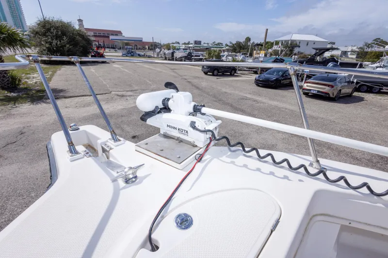 Slide: The Image of 1997 Robalo R230 Center Console with Minn Kota trolling motor in a parking lot. - 29