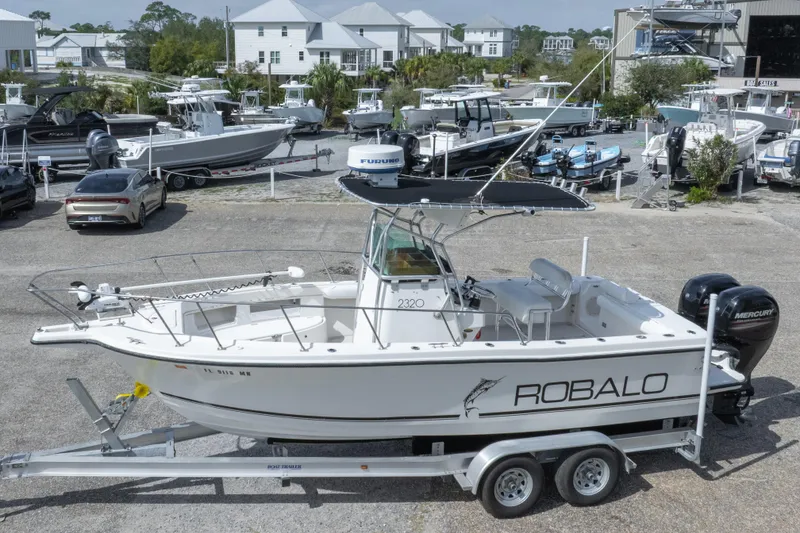 Slide: The Image of 1997 Robalo R230 Center Console boat on trailer in marina setting. - 3