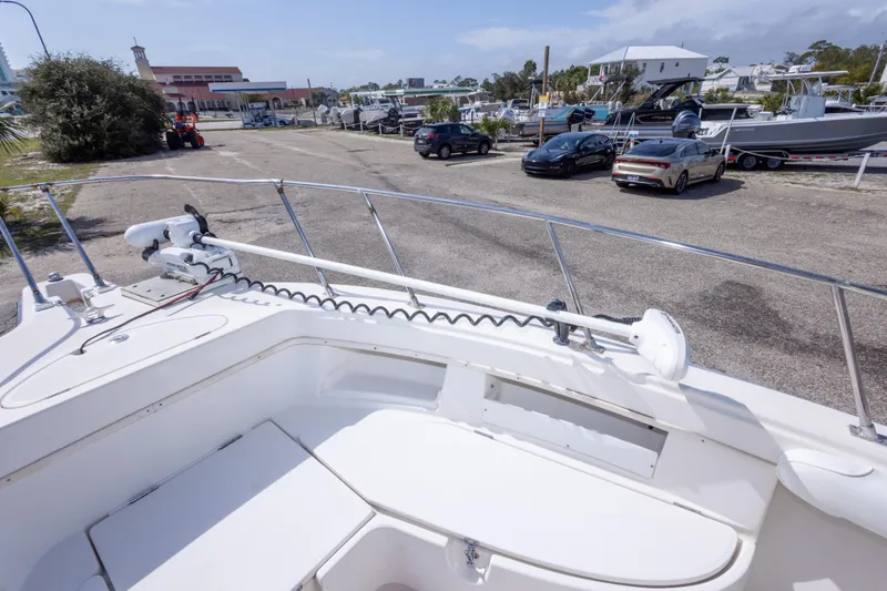 Slide: The Image of 1997 Robalo R230 Center Console boat docked near parked cars and buildings. - 30
