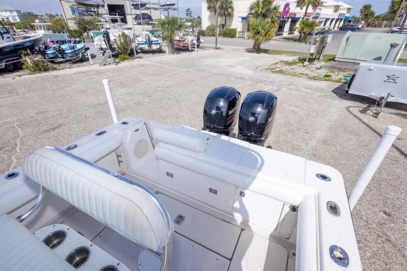 Slide: The Image of 1997 Robalo R230 Center Console boat with dual outboard motors in a marina setting. - 31