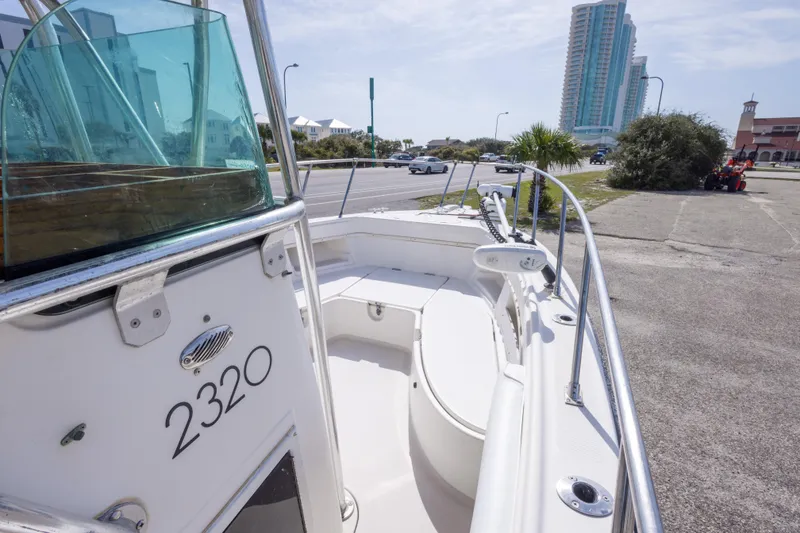 Slide: The Image of 1997 Robalo R230 Center Console boat docked near a city street. - 35