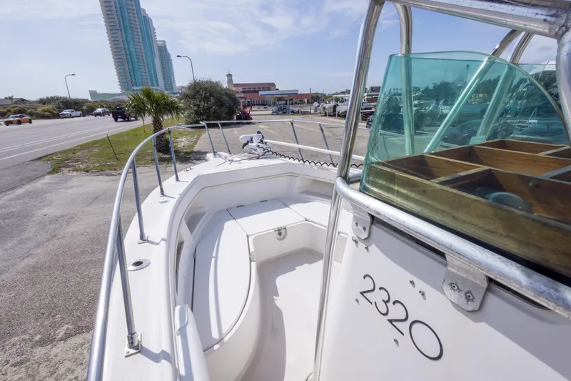 Slide: The Image of 1997 Robalo R230 Center Console boat parked near a coastal road. - 36