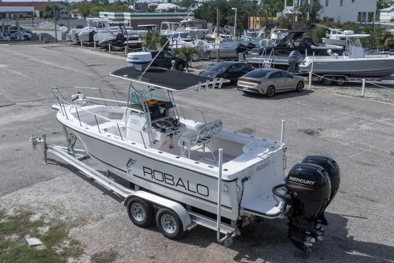 Slide: The Image of 1997 Robalo R230 Center Console boat on trailer with Mercury engine in a marina. - 4