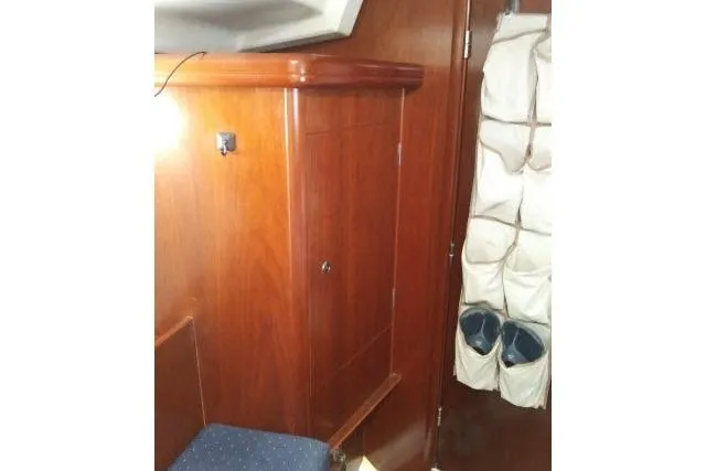 Slide: The Image of Interior of 2005 Beneteau 393 yacht with wooden cabinetry and storage pockets. - 13