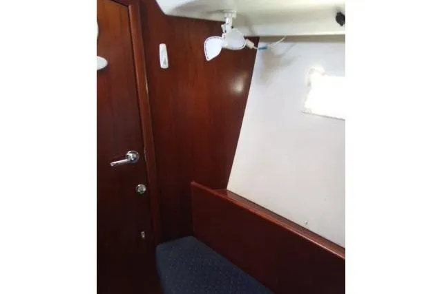 Slide: The Image of Interior cabin of 2005 Beneteau 393 sailboat with wooden paneling and seating. - 14