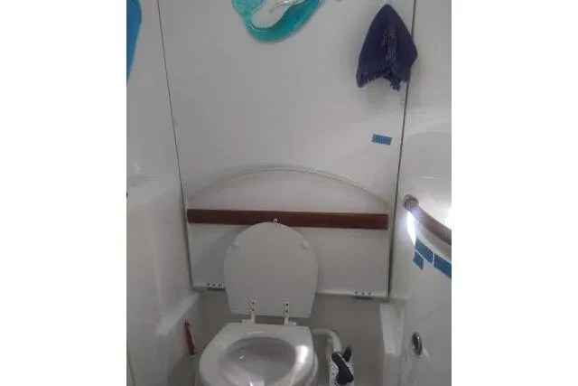Slide: The Image of Beneteau 393 2005 yacht bathroom with toilet and nautical decor. - 16