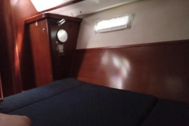 Slide: The Image of Interior cabin of 2005 Beneteau 393 yacht with wooden paneling and porthole. - 22