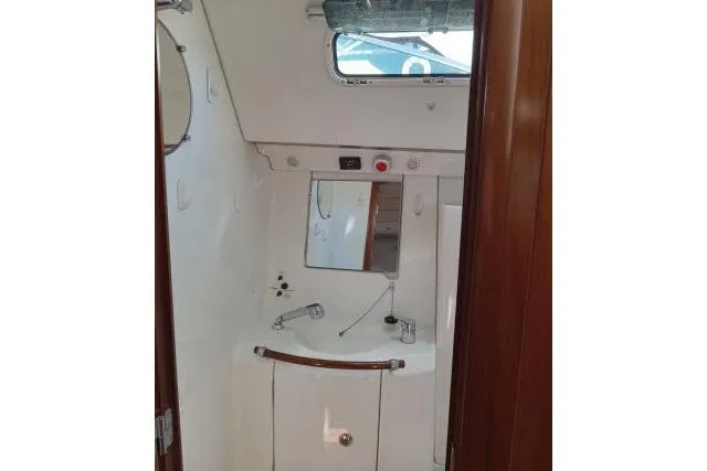 Slide: The Image of Interior view of 2005 Beneteau 393 yacht bathroom with sink and mirror. - 26