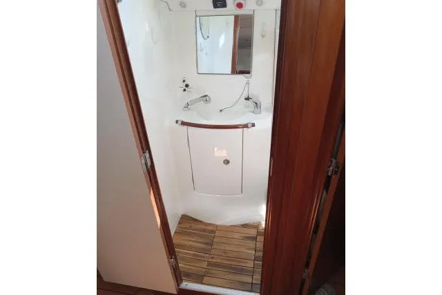 Slide: The Image of Compact bathroom in 2005 Beneteau 393 yacht with wooden flooring and modern fixtures. - 27