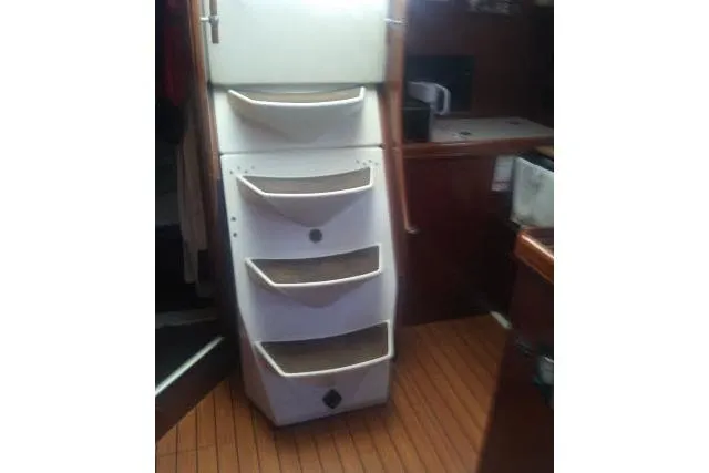 Slide: The Image of Interior of 2005 Beneteau 393 sailboat with wooden flooring and storage compartments. - 29