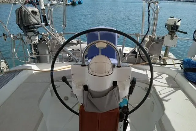 Slide: The Image of Cockpit of a 2005 Beneteau 393 sailboat with steering wheel and ocean view. - 30