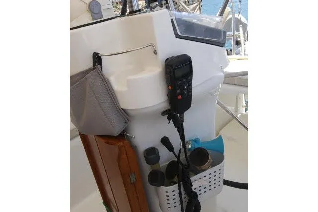 Slide: The Image of Cockpit of 2005 Beneteau 393 sailboat with navigation equipment and storage compartments. - 38