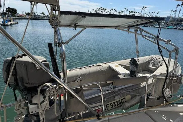 Slide: The Image of Beneteau 393 sailboat with dinghy, docked in a marina, 2005 model. - 41