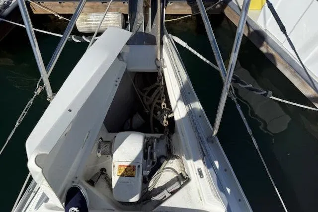 Slide: The Image of Bow of 2005 Beneteau 393 sailboat with anchor chain and winch system. - 43