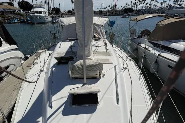 Slide: The Image of 2005 Beneteau 393 sailboat docked in a marina, surrounded by other boats. - 44