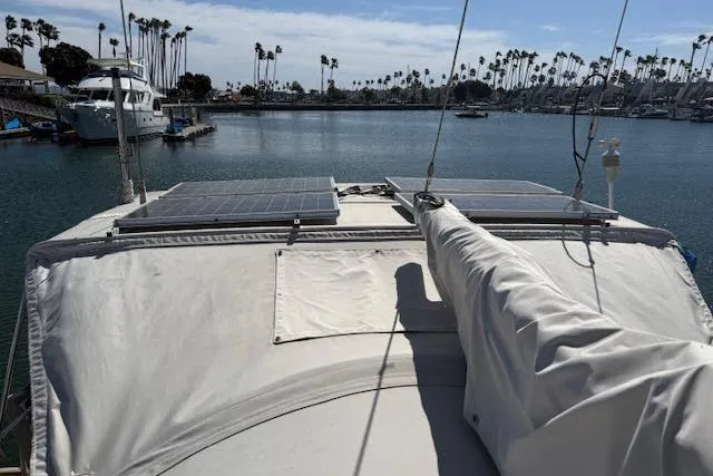 Slide: The Image of Sailboat Beneteau 393 (2005) with solar panels docked in a marina. - 45