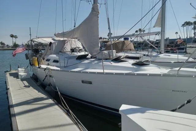 Slide: The Image of Sailboat Beneteau 393, 2005 model, docked at marina with clear sky. - 54