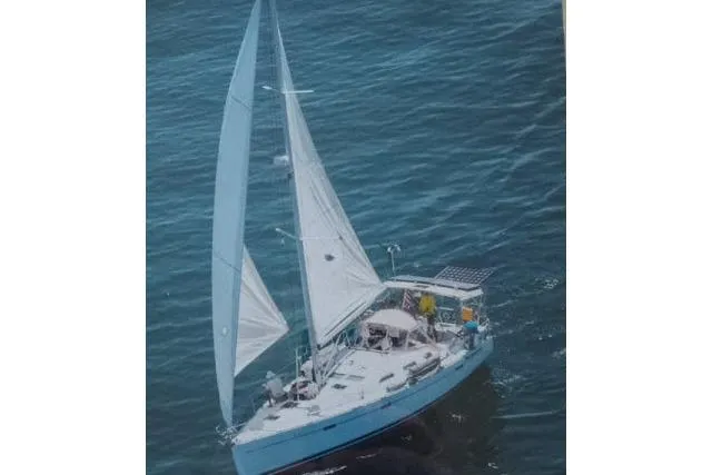 Slide: The Image of Sailing yacht Beneteau 393, 2005 model, cruising on open water with full sails. - 55