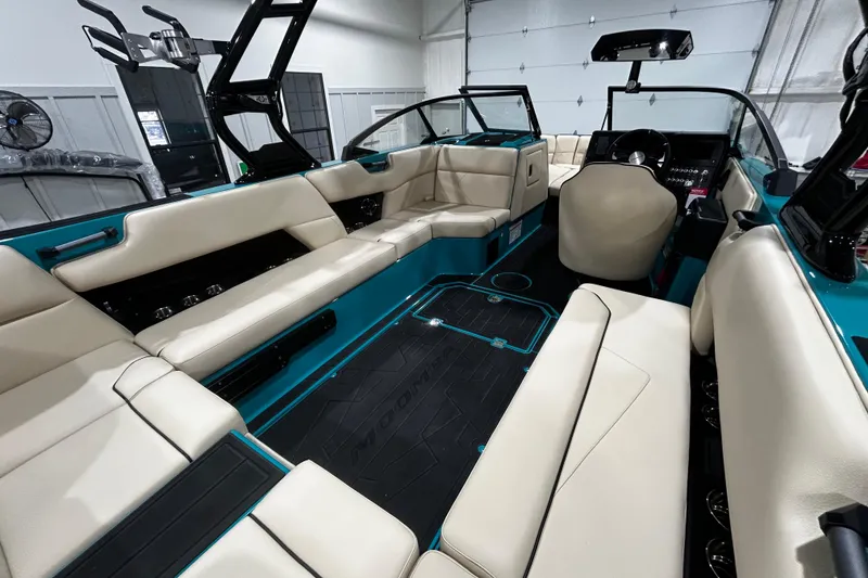 Slide: The Image of 2026 Moomba Tykon boat interior with beige seating and modern design. - 5