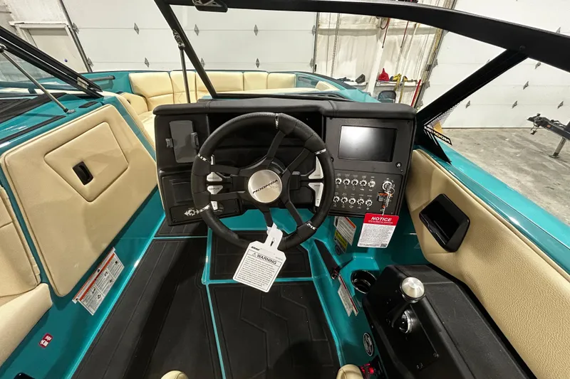 Slide: The Image of Interior view of 2026 Moomba Tykon boat dashboard with steering wheel and control panel. - 6